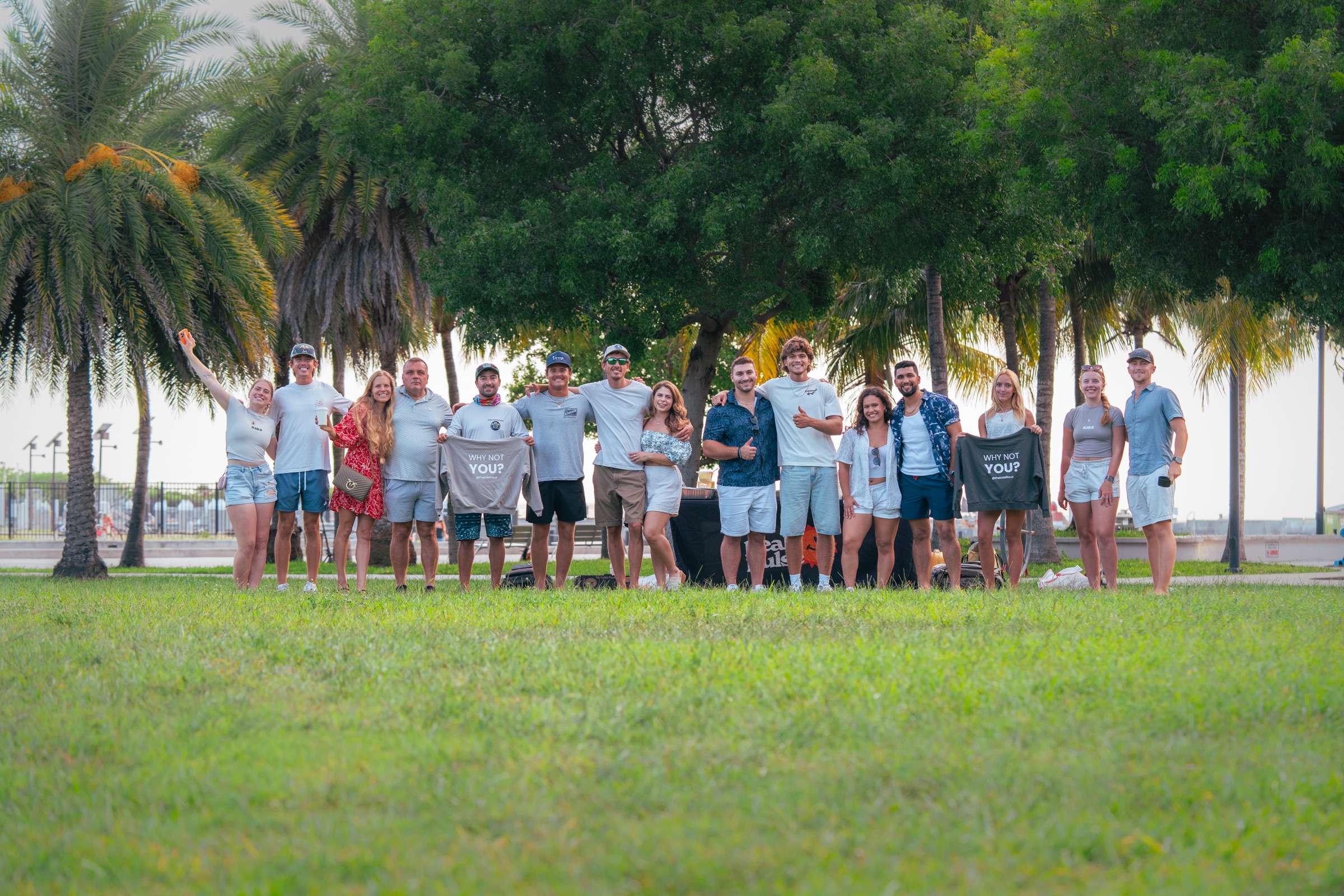 The Kids Like Us meetup group under the palms in Key West